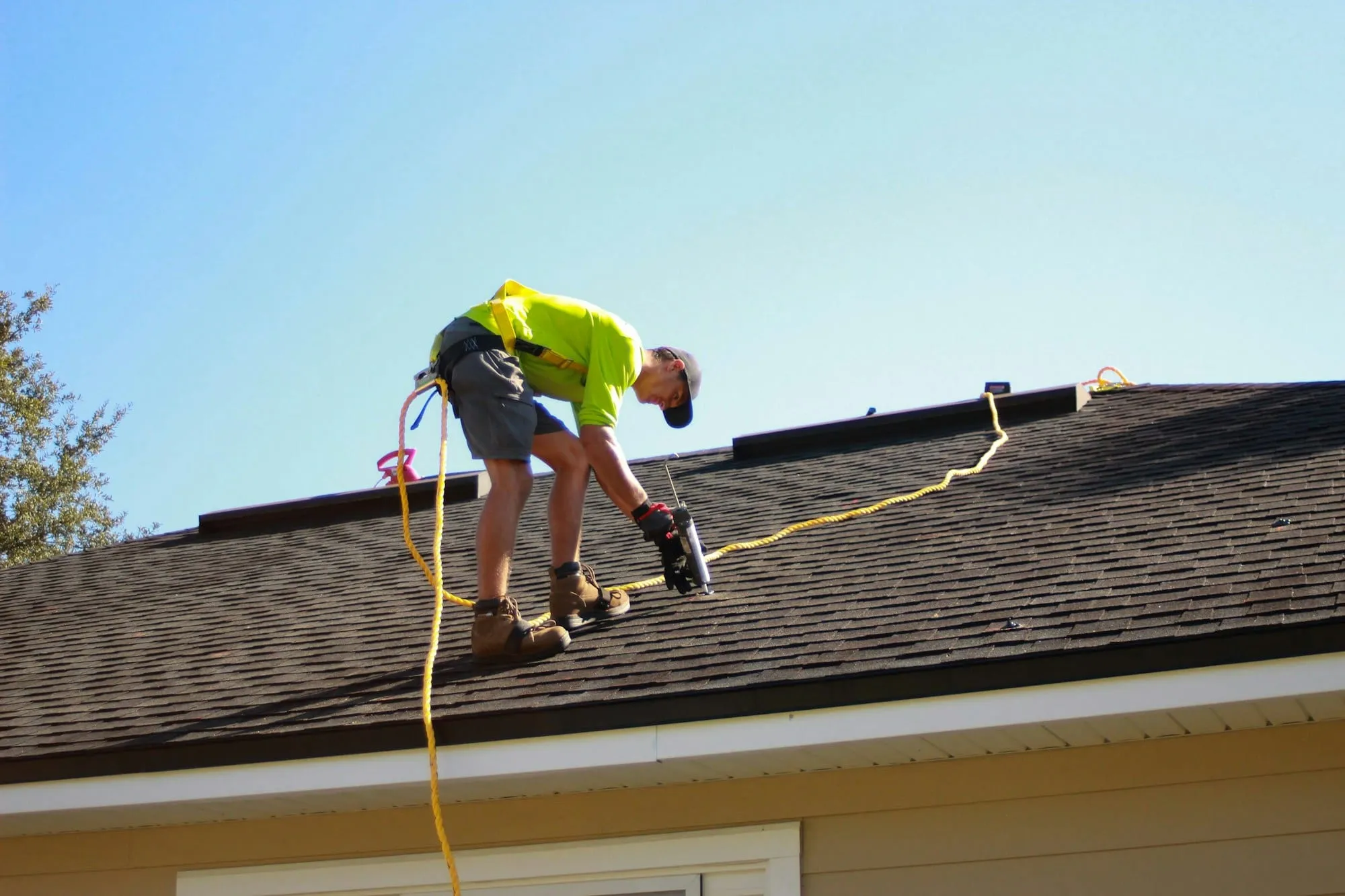Roofer fastening new shingles